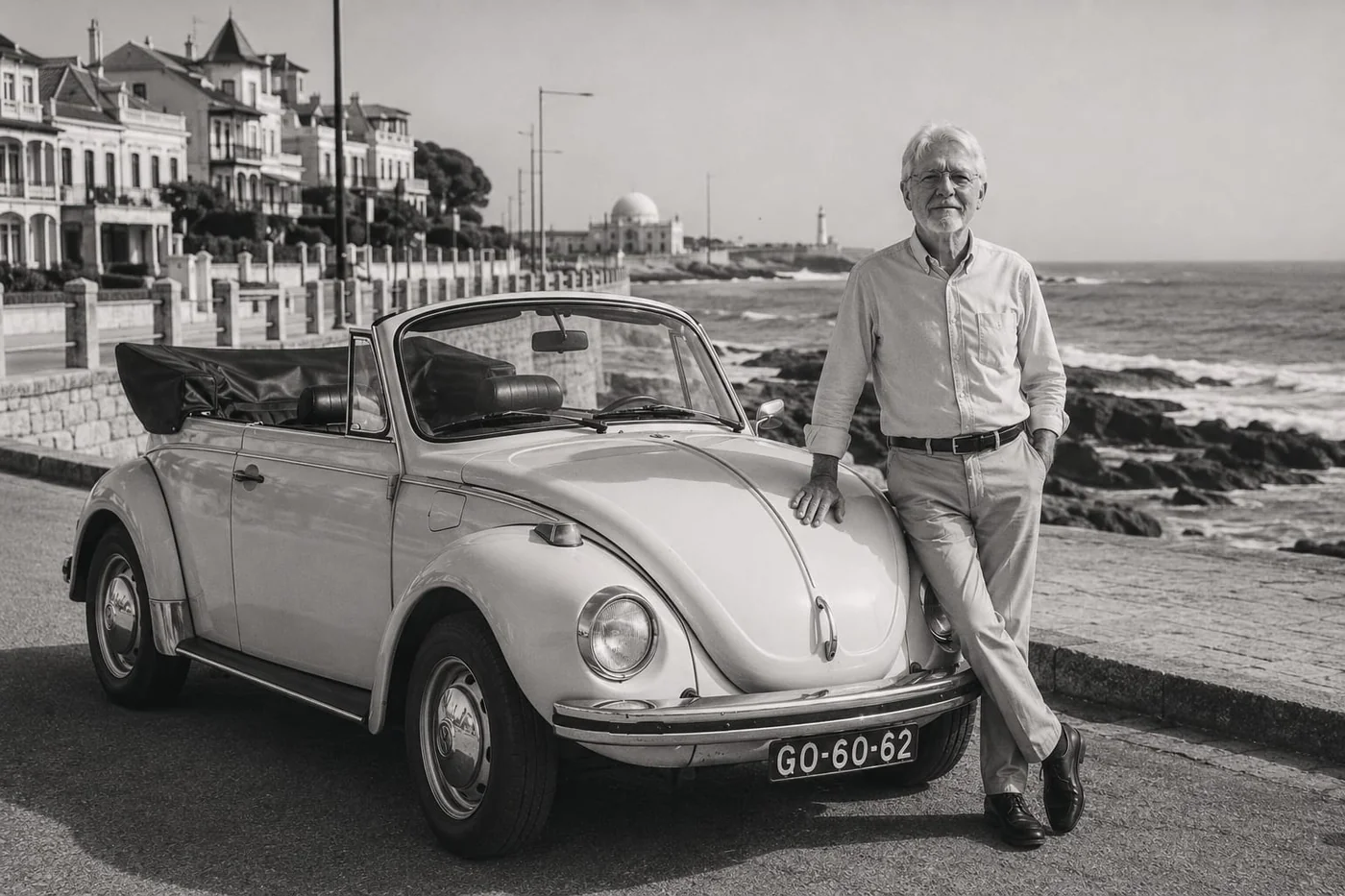 Black and white photo of a family member leaning on the vintage yellow Volkswagen Beetle convertible along the Foz do Douro coastline in Porto