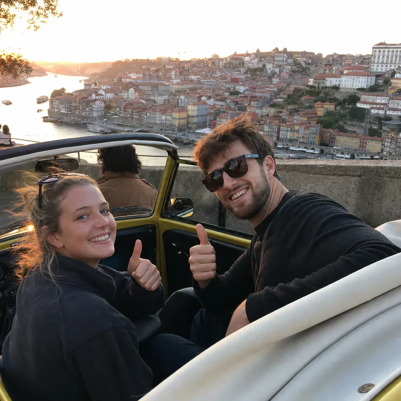 A couple giving a thumbs up from the yellow Beetle at a Porto viewpoint at sunset