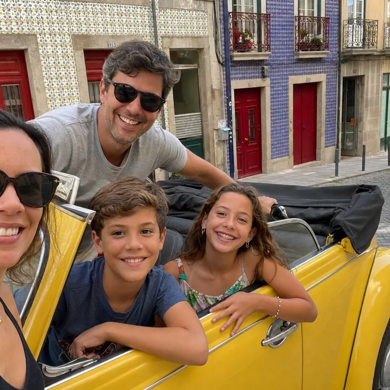 A family of four smiling around the yellow Beetle on a cobblestone street in Porto
